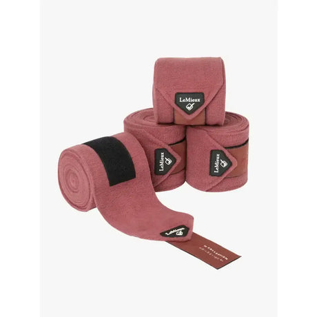 Pink suede lemieux polo bandages with black velcro straps featuring orchid luxury lemieux branding