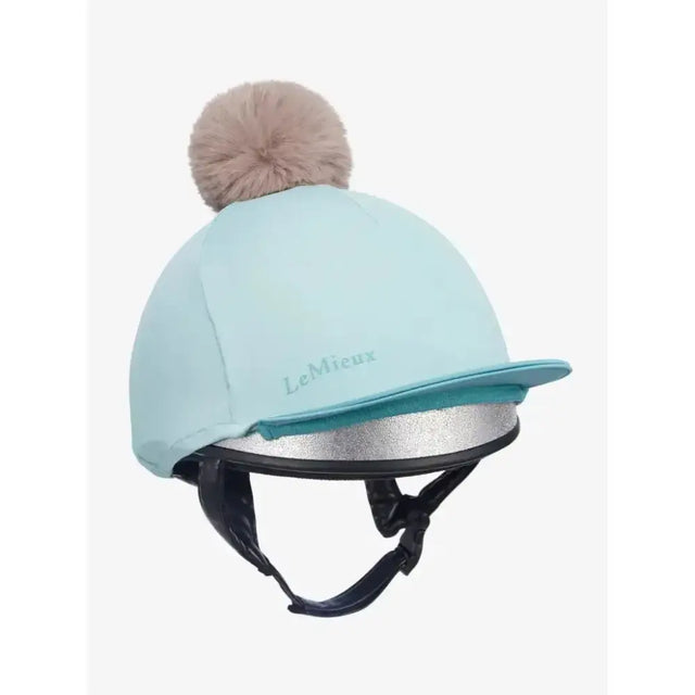 Light blue lemieux pom hat silk aqua lagoon equestrian helmet cover with fluffy beige pom pom and silver trim