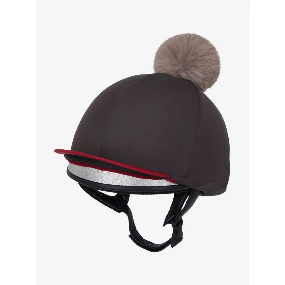 Dark gray lemieux pom hat equestrian helmet cover with red silver trim and fluffy beige pom made from silky smooth four-way silk cinder