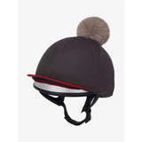 Dark gray lemieux pom hat equestrian helmet cover with red silver trim and fluffy beige pom made from silky smooth four-way silk cinder