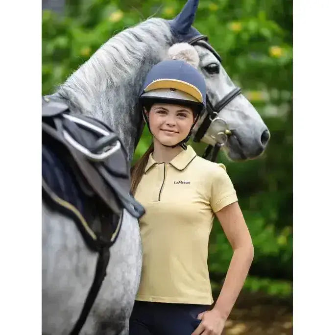 A pale yellow lemieux pom hat silk dusk mimosa polo shirt with collar short sleeves and embroidered logo on left chest