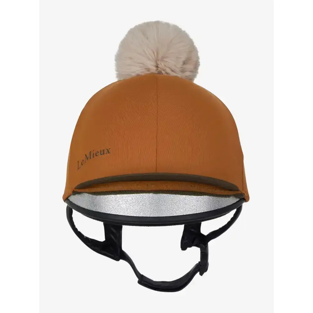 A lemieux pom hat silky smooth four-way equestrian helmet cover in warm orange silk ginger with cream pom-pom and silver lining