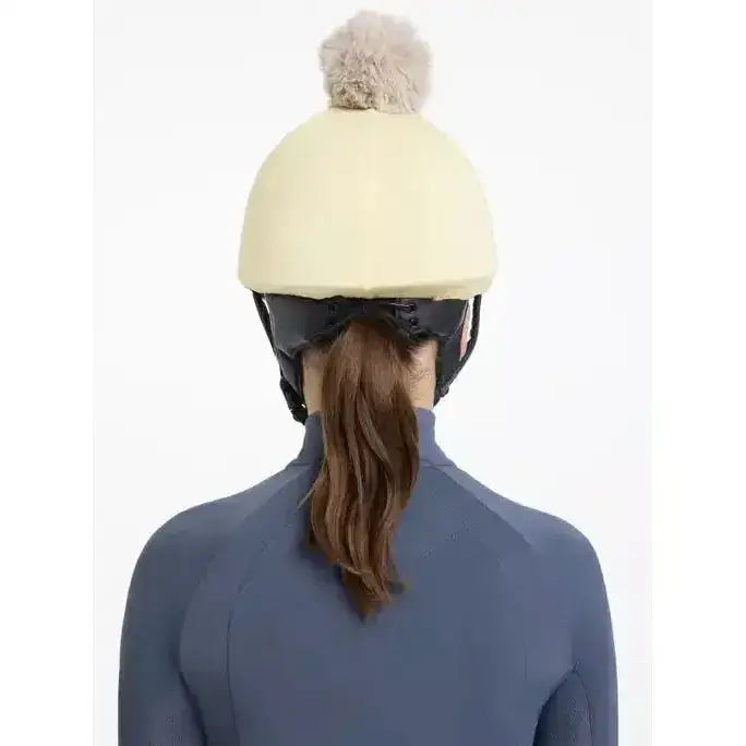 Cream-colored lemieux pom hat silk mimosa stone equestrian helmet with fluffy gray pom-pom on top