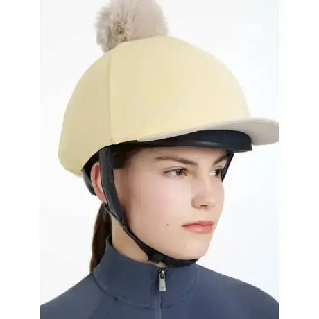 Cream-colored felt lemieux pom hat riding helmet cover with fluffy beige pom pom in silk mimosa stone color