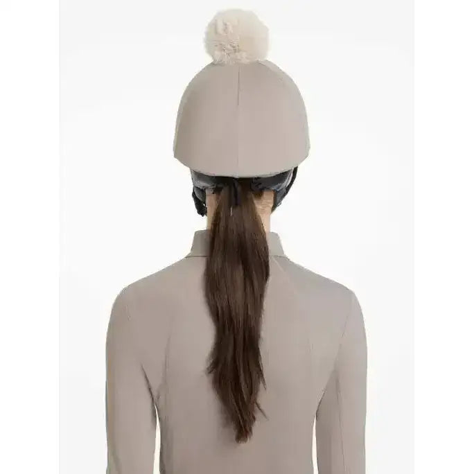 Beige lemieux pom hat equestrian helmet with a fluffy cream pom pom in silk pecan stone color