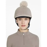 A taupe lemieux pom hat silk pecan stone with a soft fluffy pom pom and white embroidered brand name