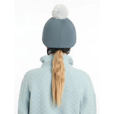 A soft gray lemieux pom hat with fluffy white pom pom made of silky smooth four way hat silk petrol material