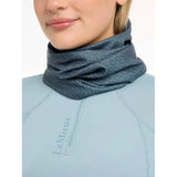 Gray neck gaiter over light blue top, featuring Lemieux Printed Stretch Snood Petrol