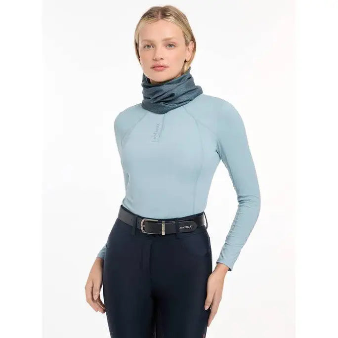 Woman wearing Lemieux Printed Stretch Snood in Petrol with light blue turtleneck sweater