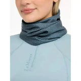 Dark gray lemieux printed stretch snood petrol worn around the model’s neck with subtle pattern and stretchy fabric