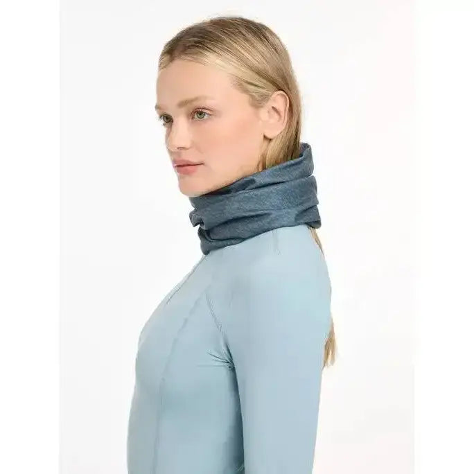 A soft heathered blue lemieux printed stretch snood petrol worn snugly around the neck for warmth and style