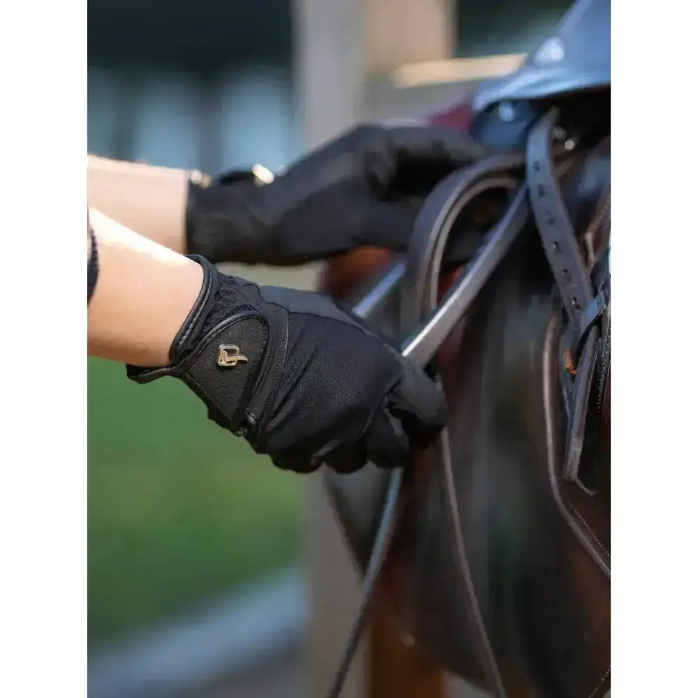 Black lemieux pro mesh riding gloves lightweight with gold logo on wrist strap showing back side