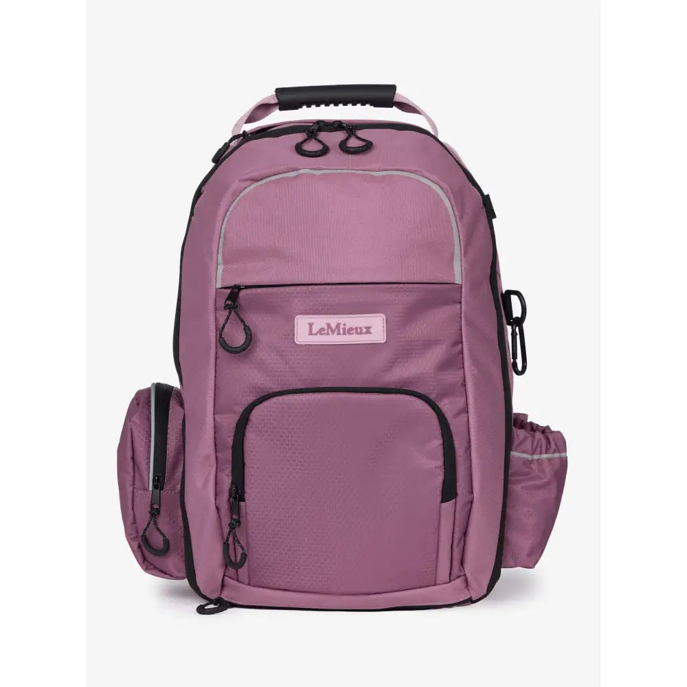 A mauve lemieux pro rucksack with black trim features multiple zippered compartments whip loop and riding hat holder