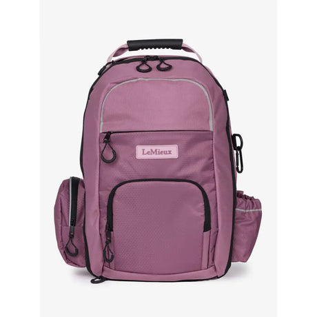 A mauve lemieux pro rucksack with black trim features multiple zippered compartments whip loop and riding hat holder