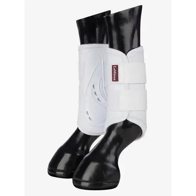 White lemieux proshell brushing boots with black glossy hoof caps for ultimate leg protection in brushing boots white