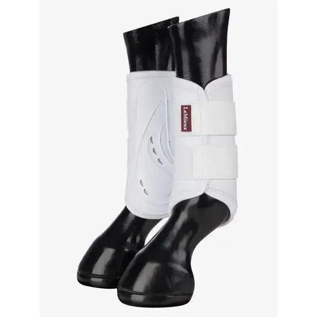White lemieux proshell brushing boots with black glossy hoof caps designed for ultimate hoof protection