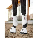 White proshell brushing boots by lemieux with black accents and adjustable straps for equestrian use