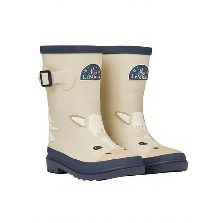 Cream-colored lemieux puddle pals kids welly palomino rain boots with giraffe face navy trim and buckle detail