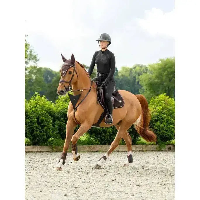 A sleek black lemieux puissance suede close riding helmet with a glossy finish and subtle ventilation slots for close contact