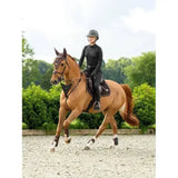 A sleek black lemieux puissance suede close riding helmet with a glossy finish and subtle ventilation slots for close contact