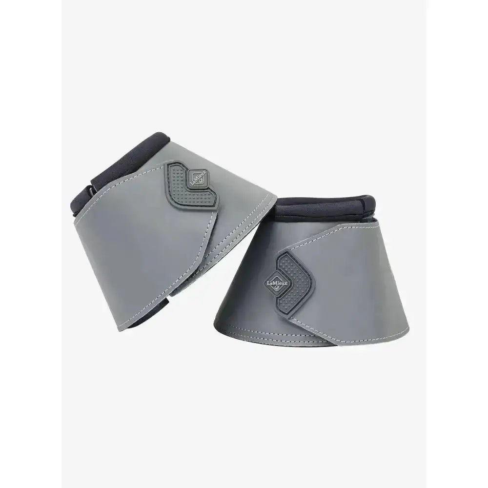 Gray leather lemieux reflective reach boots wrap with black trim and diamond logo protecting horse’s heel