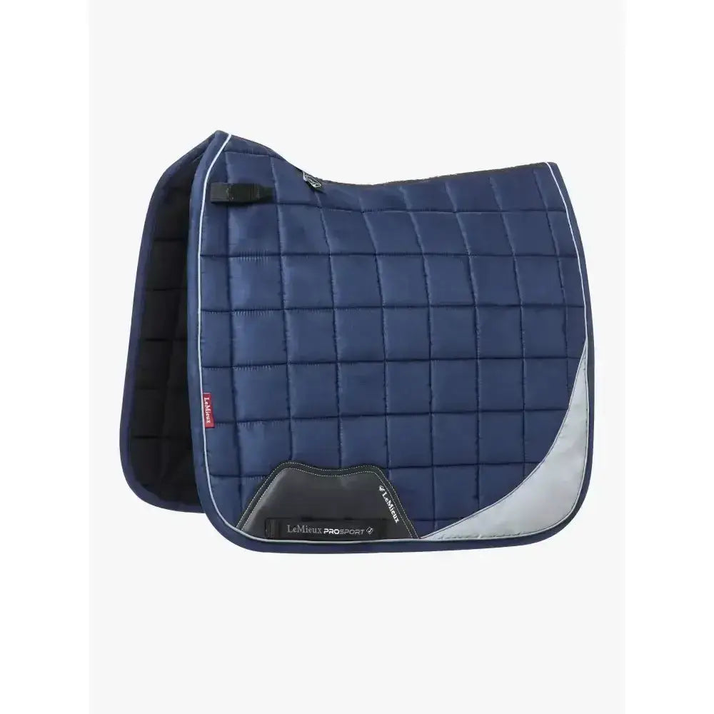Navy blue quilted lemieux reflective suede dressage saddle pad with silver and black accents for riding use