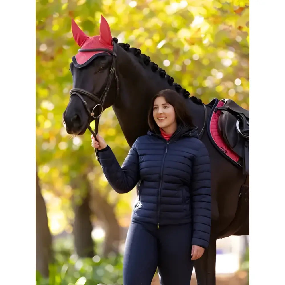 The lemieux rose hooded puffer jacket navy features a horse wearing a vibrant pink textured ear cover with pointed tips