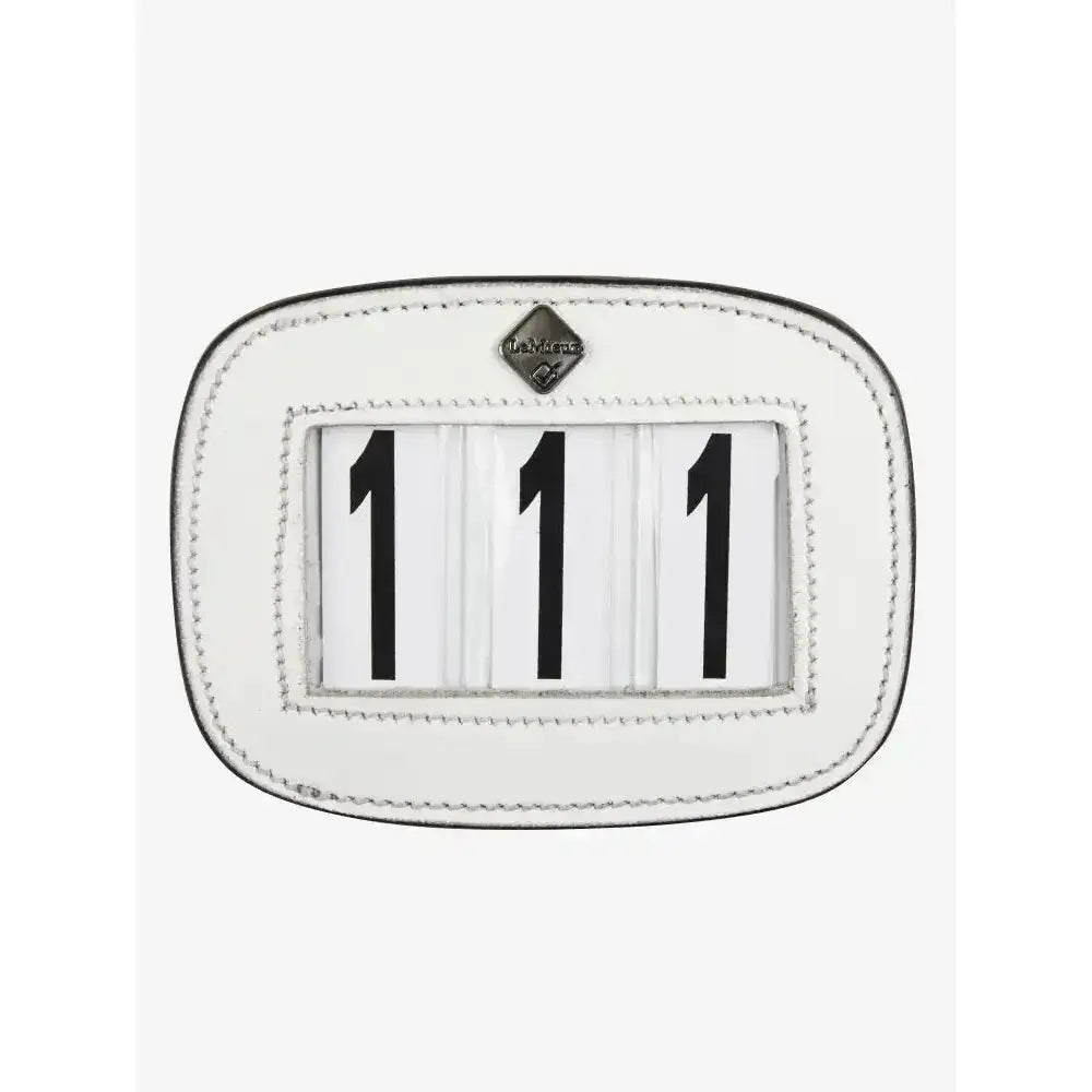 White lemieux saddle number holder made of leather with black numerals 111 and diamond logo on top