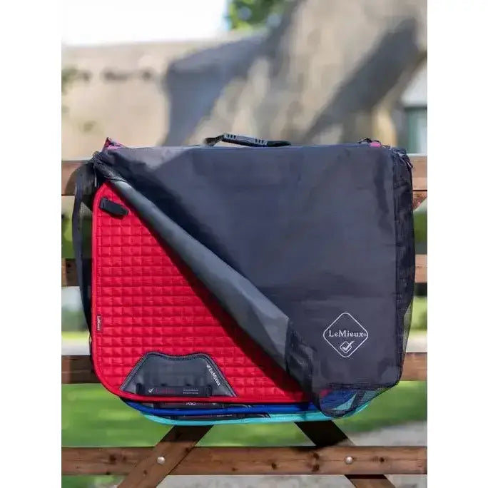 Red quilted lemieux saddle pad in a black lemieux saddle pad bag for easy transport and protection
