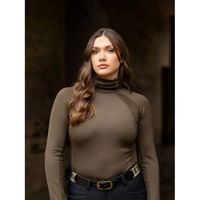 Young woman in Lemieux Sara Snood Base Layer Alpine with brown turtleneck sweater