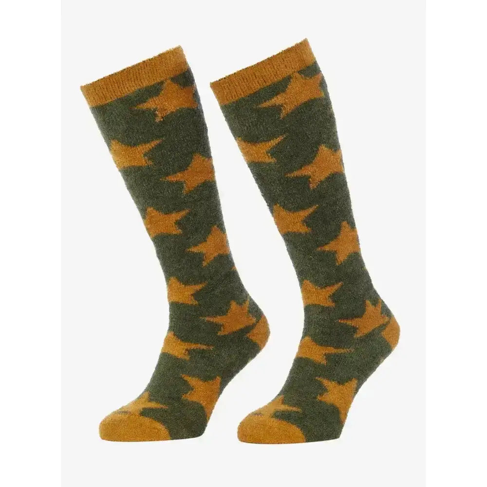 A pair of lemieux sasha star knit socks in olive green and mustard yellow with star patterns and ribbed cuffs