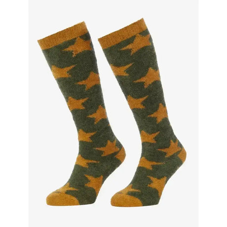 A pair of lemieux sasha star knit socks in olive green and mustard yellow with star patterns and ribbed cuffs