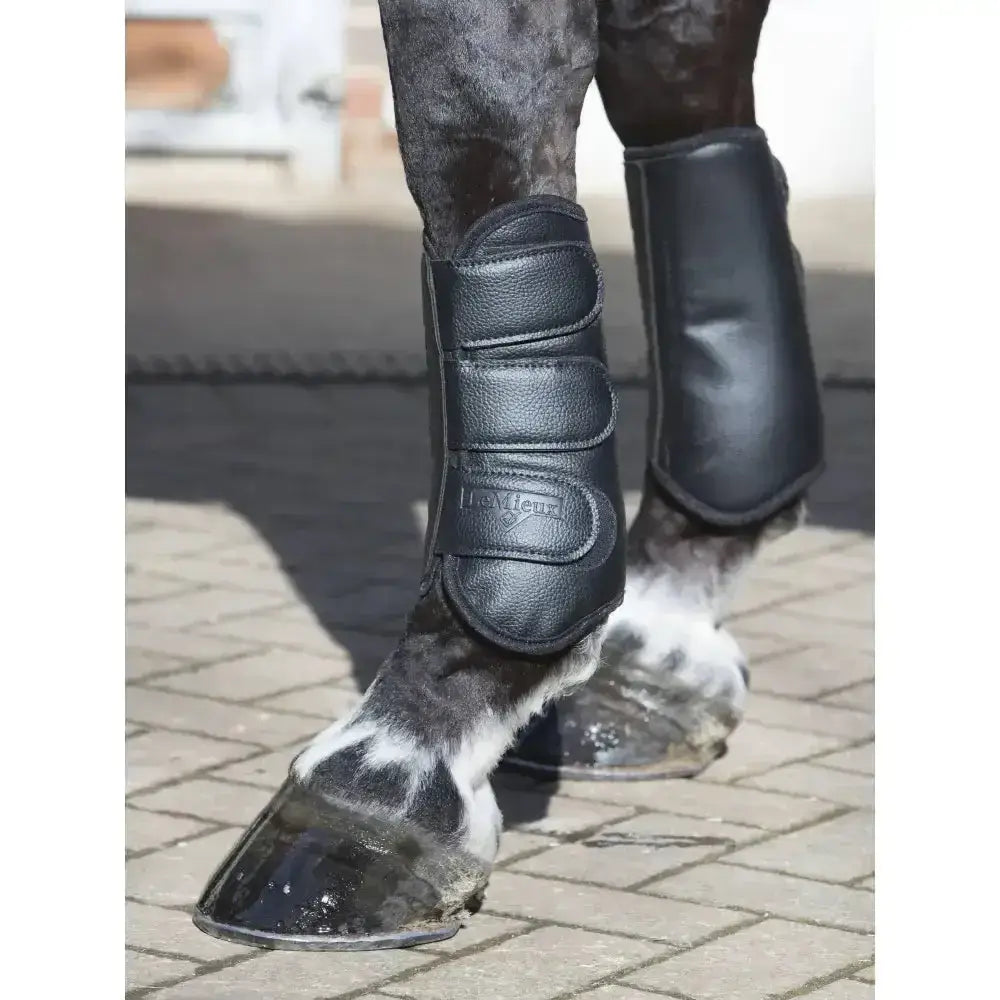 Black leather lemieux schooling boots with strike proof shell, three adjustable straps, and subtle embossed logo