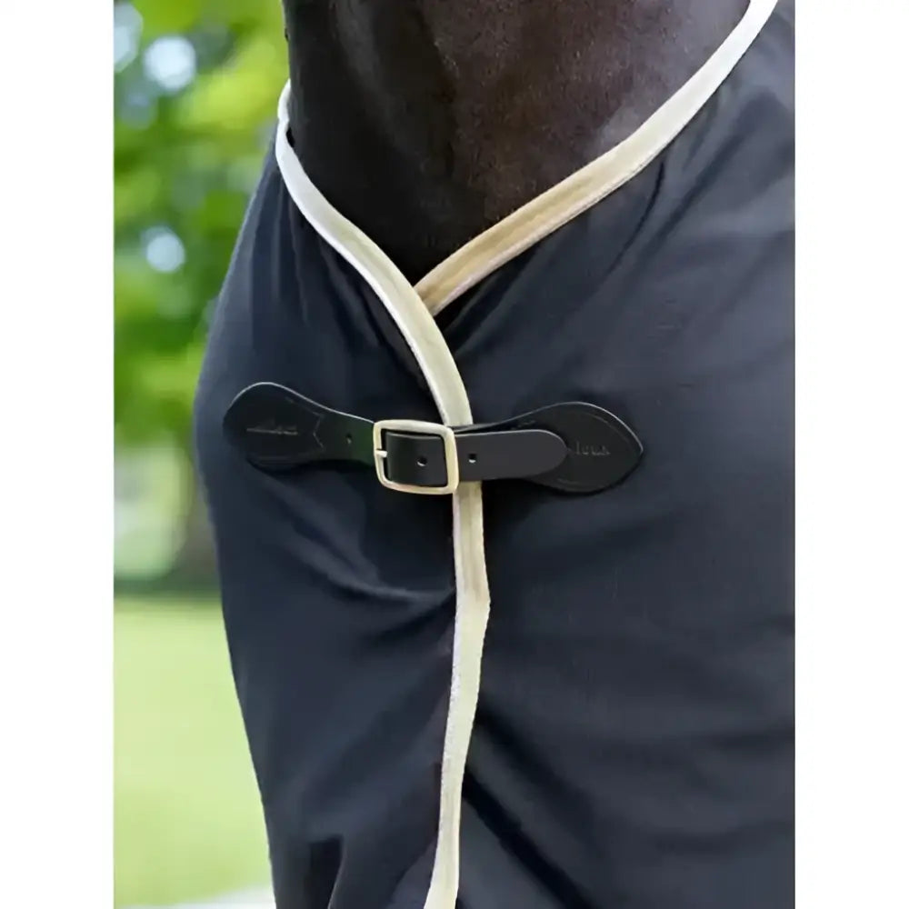 Black horse wearing lemieux scrim black cooler rug with cream trim and black leather buckle for cooling comfort