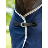 Navy blue horse blanket with white trim and black leather buckle from lemieux scrim navy collection