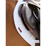 Black leather close contact half saddle with brown edges resting on white lemieux self-cool close contact half square pad