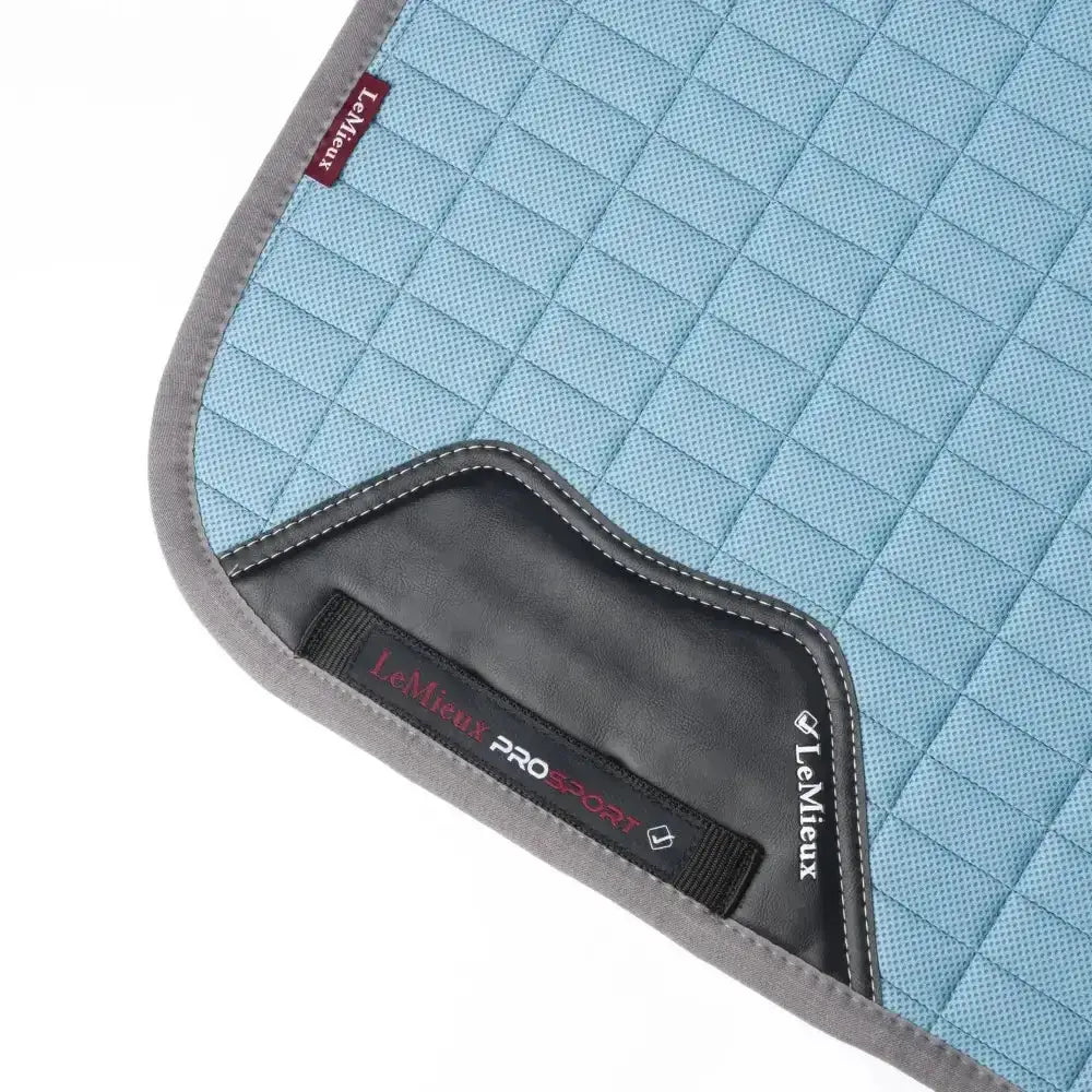 Light blue quilted lemieux self-cool dressage square with gray trim and black leather accent for riding comfort
