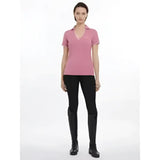 A soft pink lemieux serena sports polo shirt with a subtle v-neckline and short sleeves in smooth cotton fabric