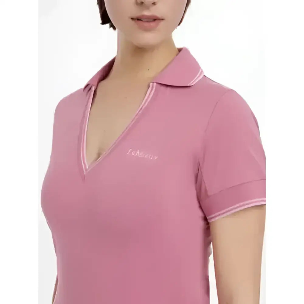 A soft pink lemieux serena sports polo with short sleeves classic collar and ribbed trim perfect for active wear