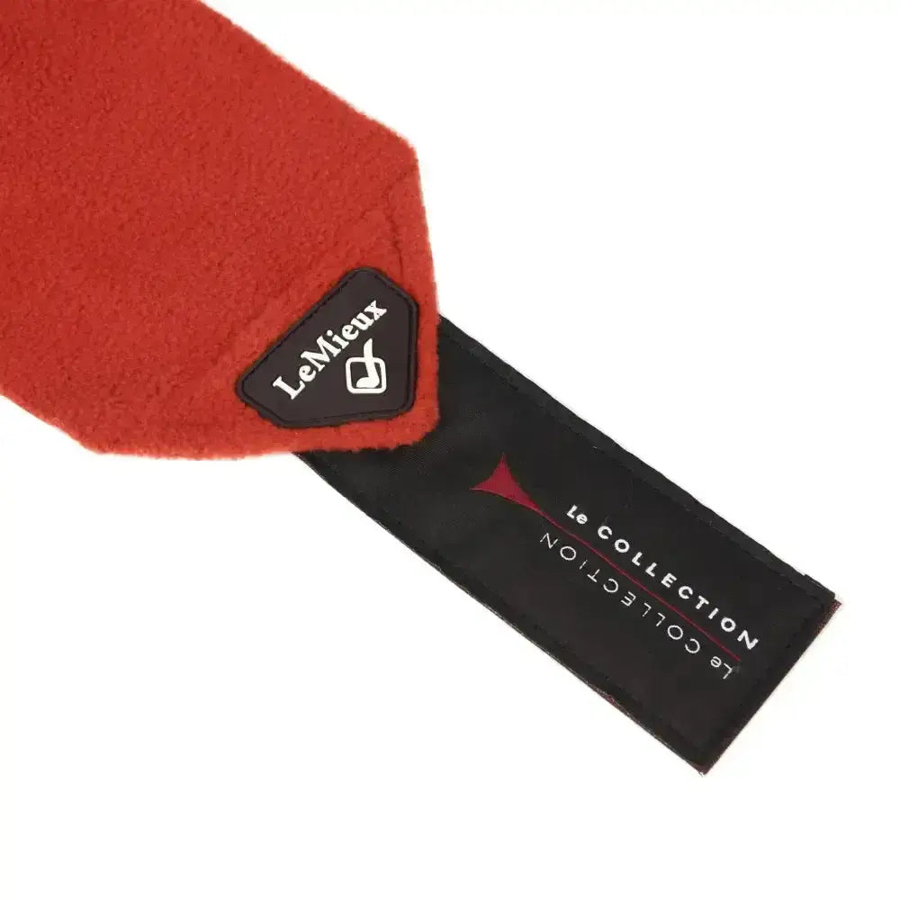 A vibrant red plush-felt scarf with a lemieux sienna classic black tag from the classic polo bandages set of 4
