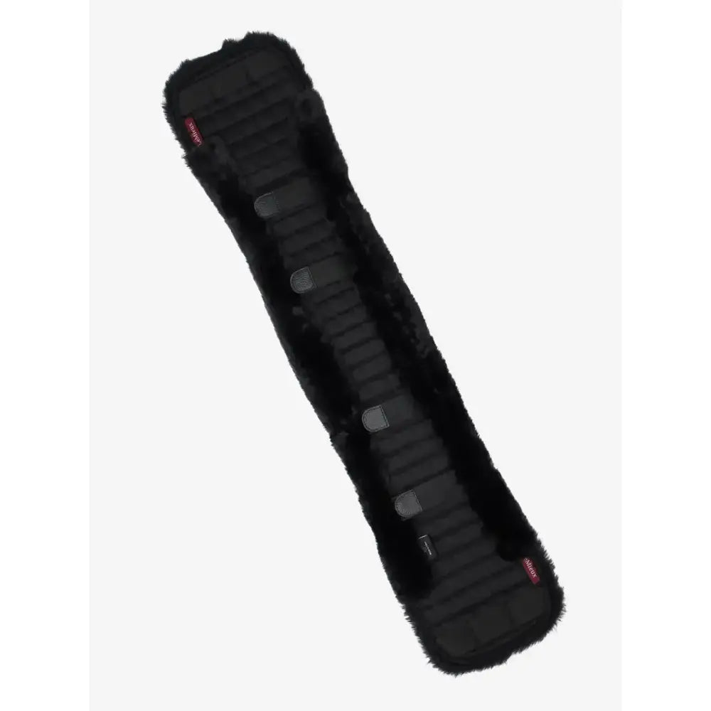Black faux fur lemieux simuwool dressage girth cover with ribbed texture and gray plastic buckles in black