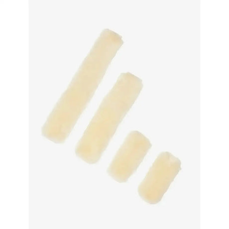 Four pale yellow foam rollers of varying sizes part of the lemieux simuwool headcollar faux lambskin headcollar set natural