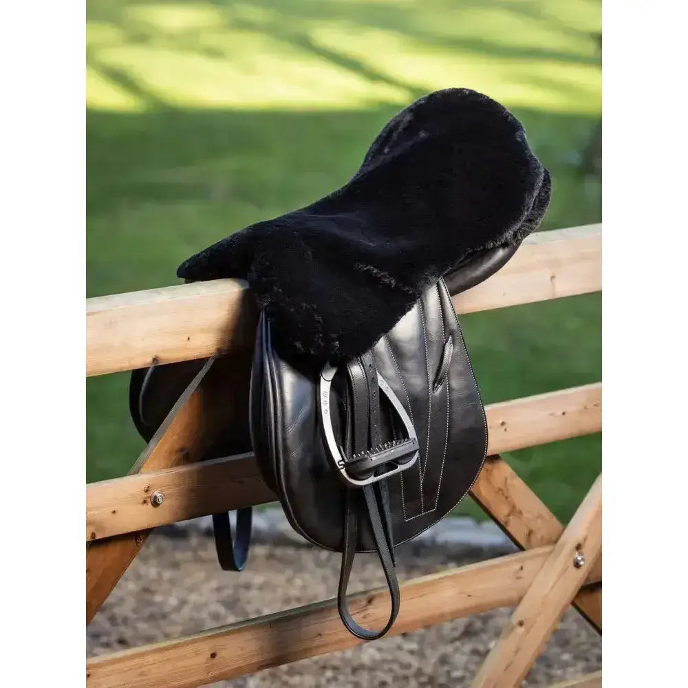 Black leather saddle with a plush black lemieux simuwool seat saver featuring soft sheepskin for extra comfort