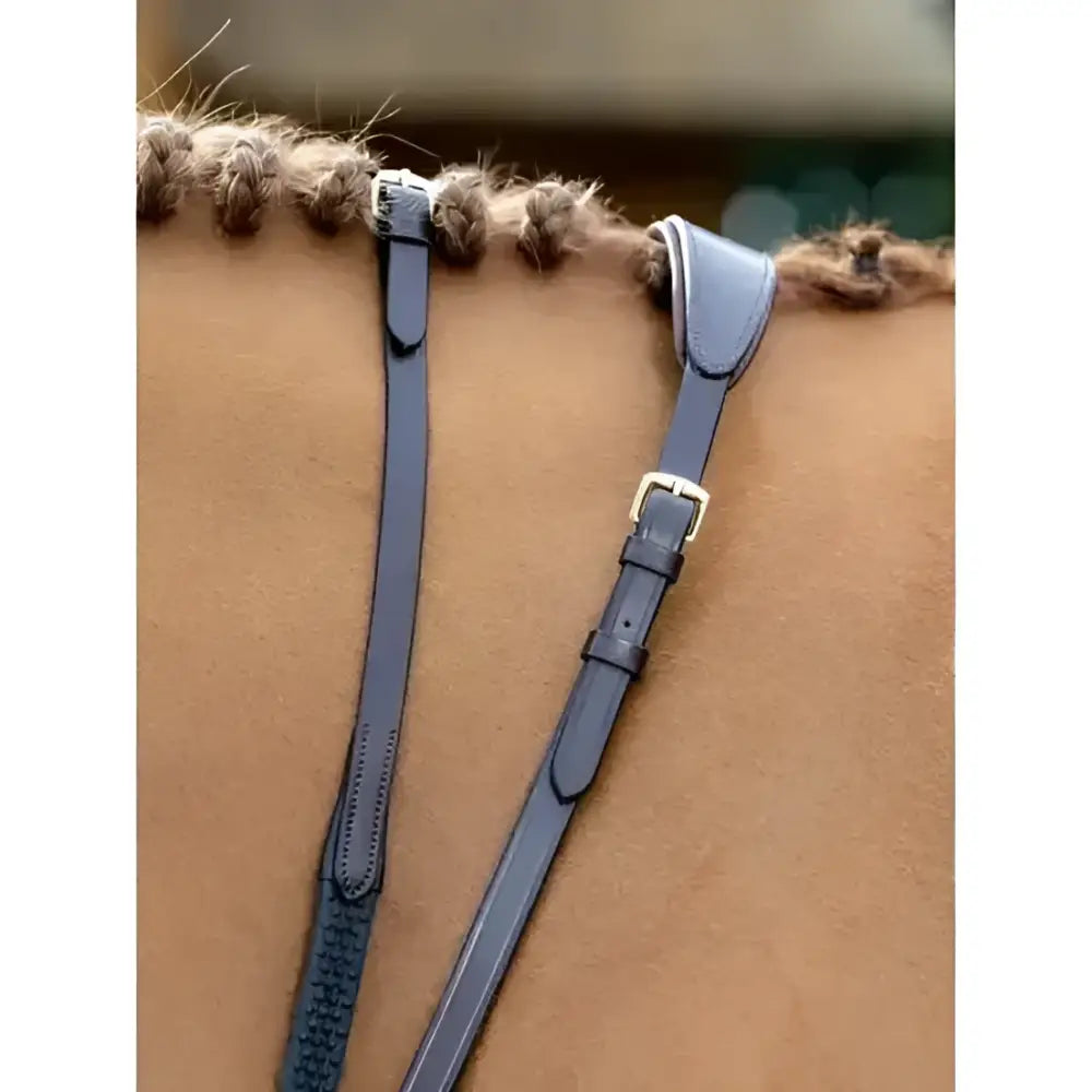 Dark blue leather horse bridle straps with gold buckles and braided edges in lemieux soft rubber reins stoppers brown brass