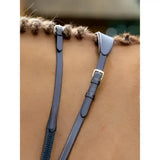 Dark blue leather horse bridle straps with gold buckles and braided edges in lemieux soft rubber reins stoppers brown brass
