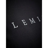 White embossed lemi letters on textured black fabric of lemieux sports t-shirt with sweat-wicking fabric