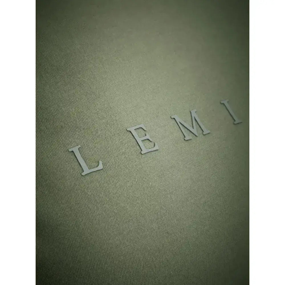 The embossed lemi logo in silver on textured olive green fabric of lemieux sports t-shirt with sweat-wicking fabric
