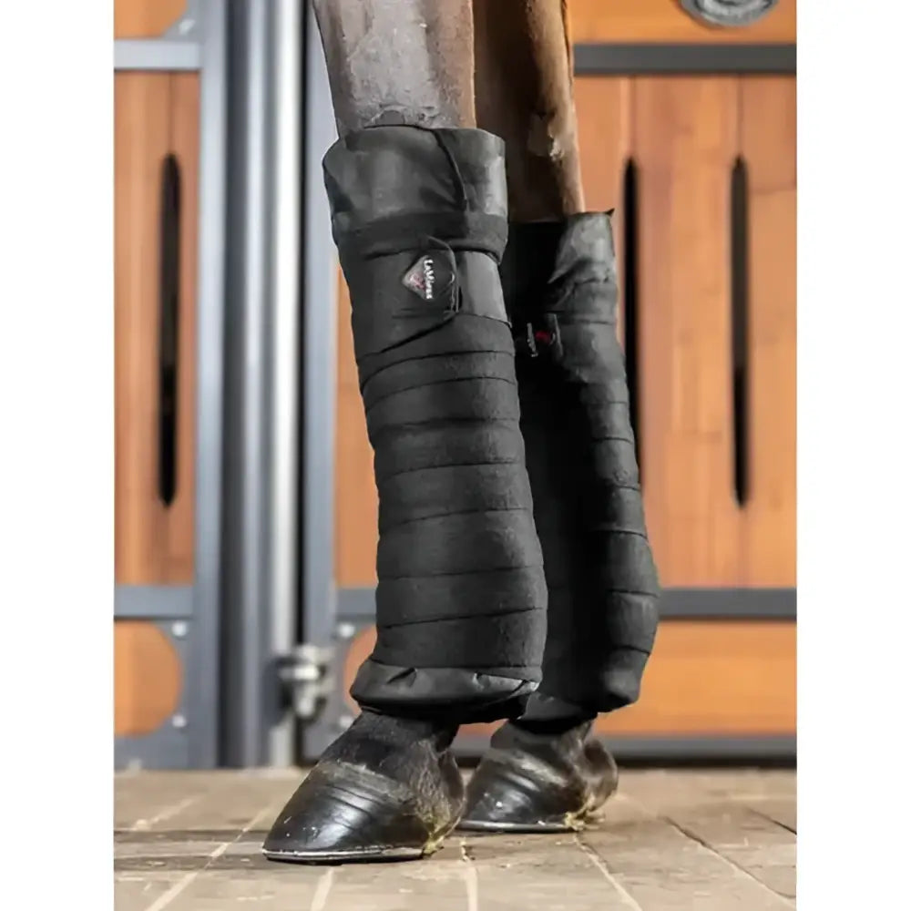 Black lemieux stable bandages with quilted padded design and loop tab featuring a small logo patch