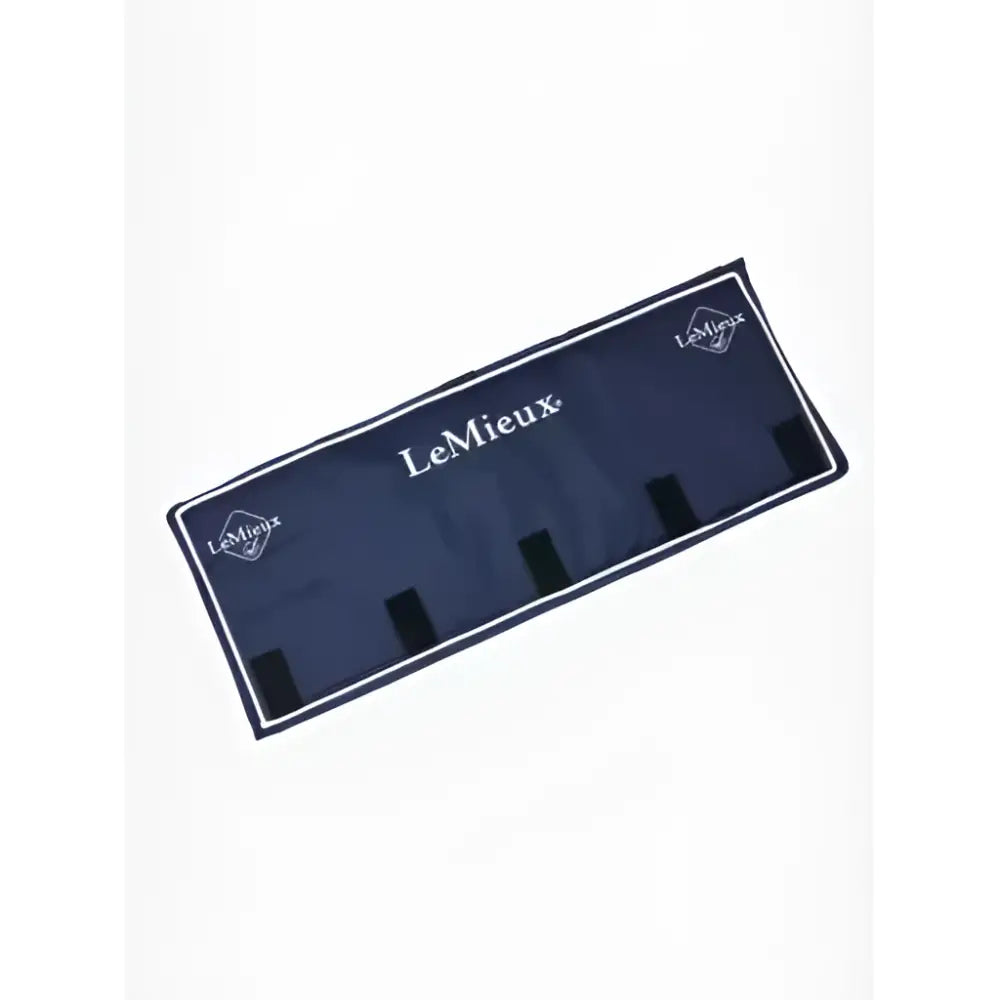 Navy blue lemieux stable head protector with white trim and black strap loops shown on stable door frame