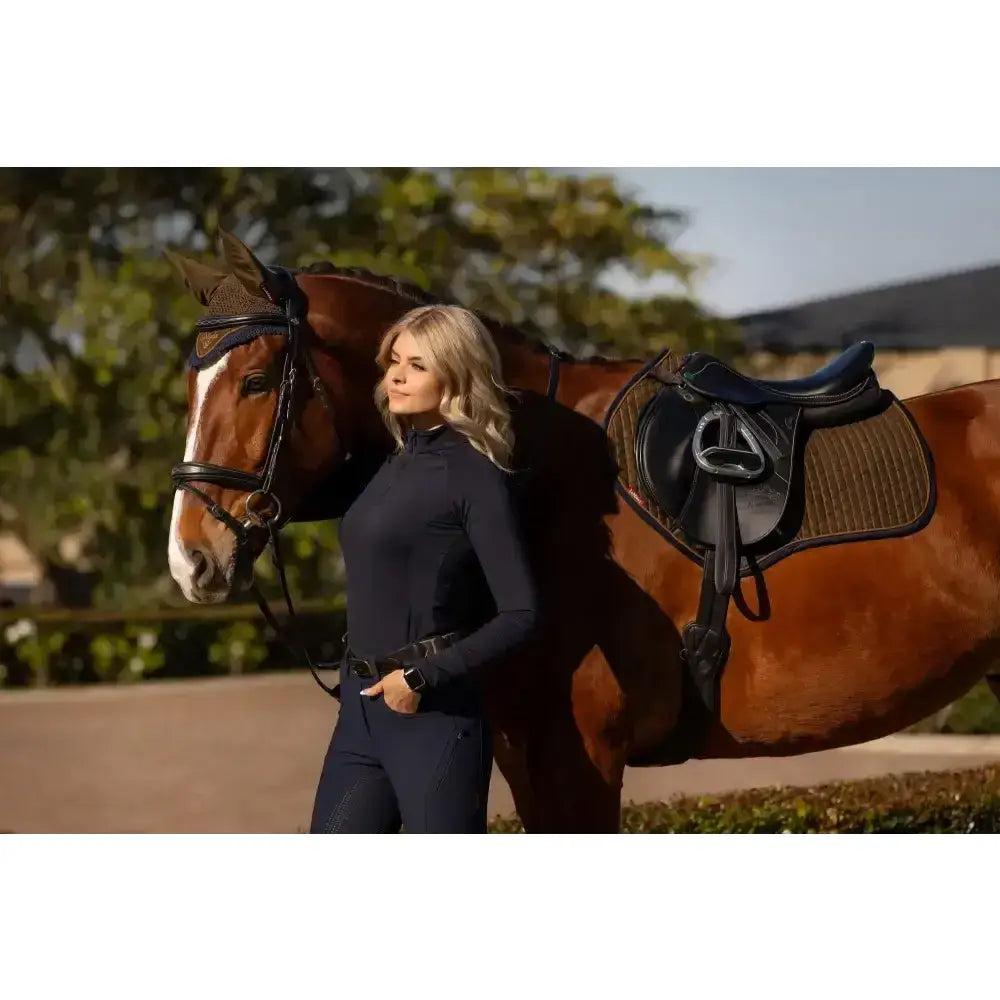 A sleek dark navy lemieux suede close contact square alpine equestrian outfit with fitted long sleeves and matching pants